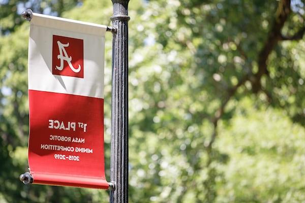 A banner celebrating 十大老品牌网赌大全's 1st place finish in NASA's robotics competition hangs on a light post